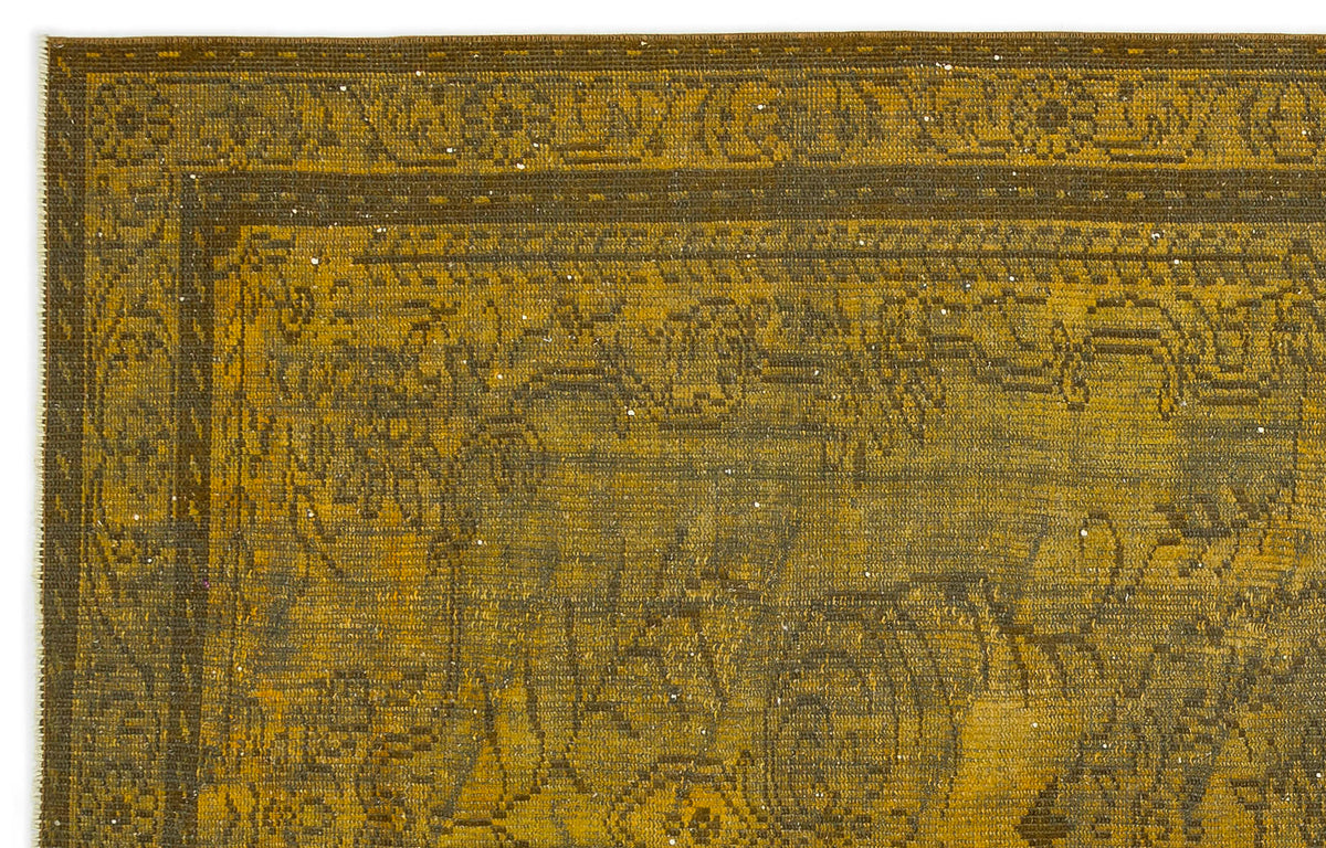 Mustard yellow and dark brown rug with a distressed traditional floral border and central medallion pattern.