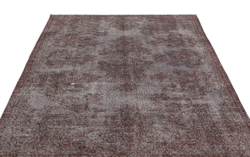 Load image 1 in gallery view. Dark brown and grey distressed vintage-style rug with a faded floral medallion pattern.