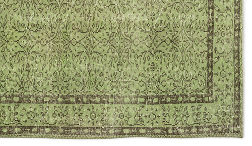 Load image 1 in gallery view. Sage green and dark brown distressed rug with a traditional floral medallion pattern and a geometric border.
