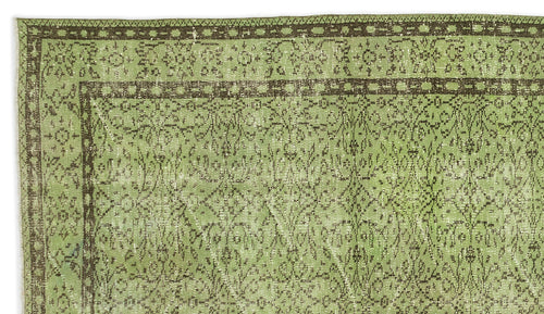 Load image 1 in gallery view. Sage green and dark brown vintage-style rug with a distressed floral medallion border and intricate central pattern.