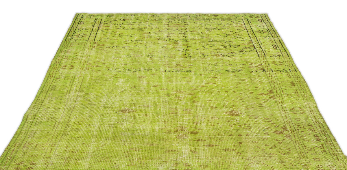 Chartreuse distressed vintage-style rug with a faded traditional medallion pattern and a bordered edge.
