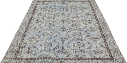 Load image 1 in gallery view. Light blue and brown distressed rug with a traditional floral medallion pattern and a dark border on a white background.