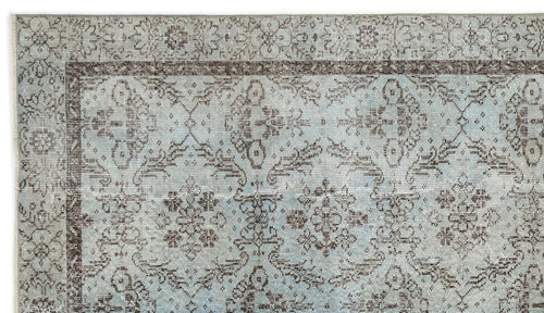 Load image 1 in gallery view. Light blue and brown traditional rug with a distressed floral medallion pattern and a detailed border.