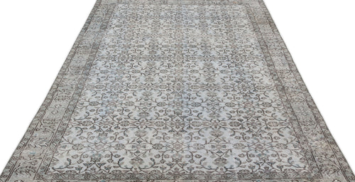 Load image 1 in gallery view. Grey and beige vintage-style rug with a repeating floral vine pattern and a decorative border on a white background.