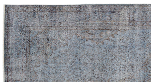 Load image 1 in gallery view. Blue and charcoal grey distressed rug with a faded traditional medallion pattern on a white background.