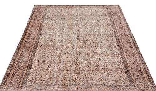 Load image 1 in gallery view. Beige and brown traditional area rug with a distressed, intricate floral pattern and a wide decorative border.