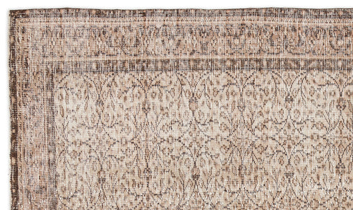 Load image 1 in gallery view. Beige and brown vintage-style rug with a distressed floral medallion pattern and a decorative border.
