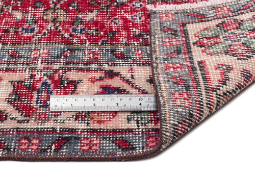 Load image 1 in gallery view. Red, pink, and grey traditional Persian-style rug with a floral medallion pattern, shown with a metal ruler for scale.