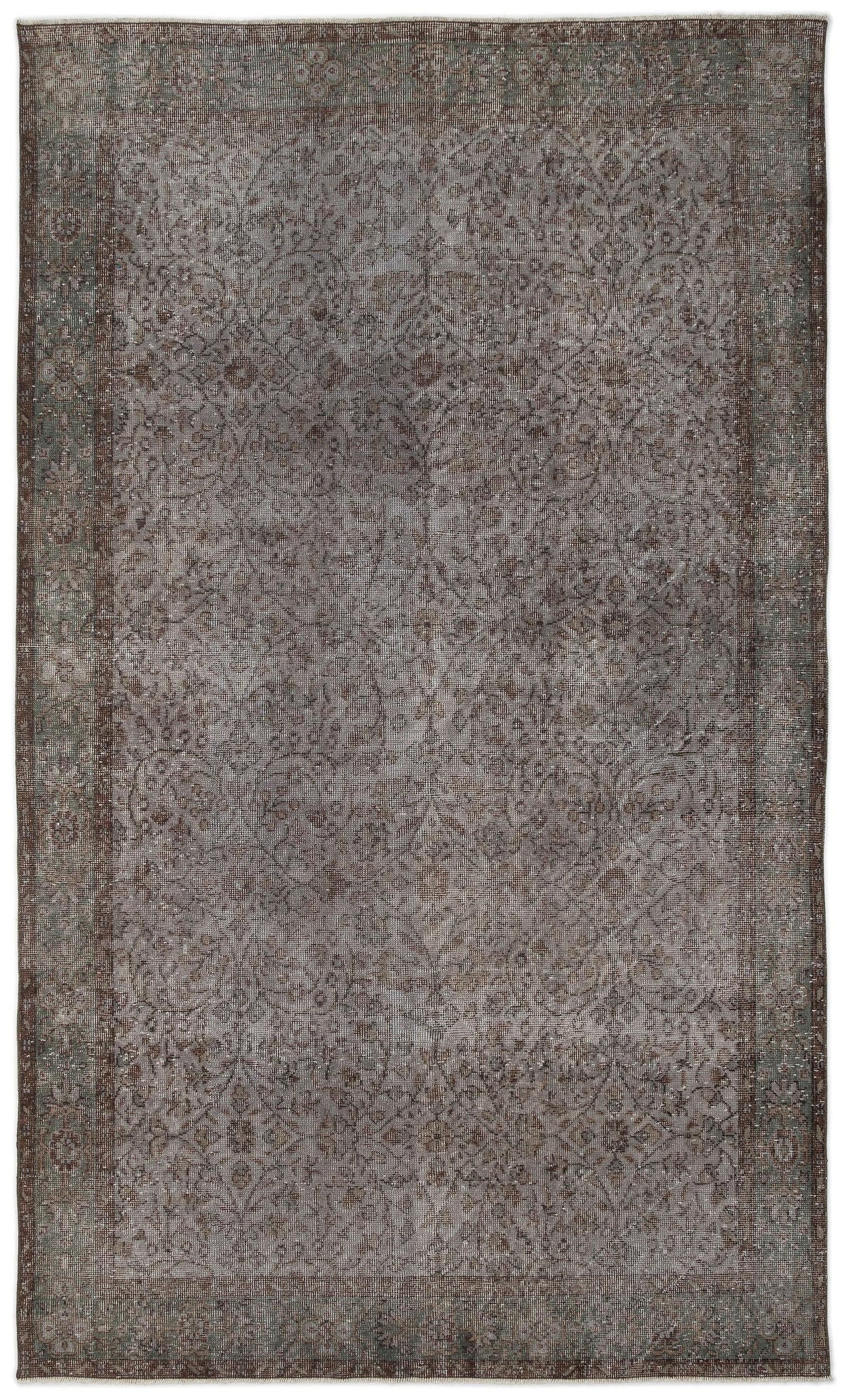 Charcoal and brown distressed vintage-style rug with a faded floral medallion pattern and a wide decorative border.