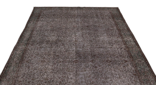 Load image 1 in gallery view. Dark brown and grey distressed rug with a traditional floral medallion pattern and a wide border.