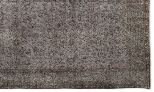 Load image 1 in gallery view. Distressed brown and grey rug with a faded traditional floral medallion pattern and a bordered edge.