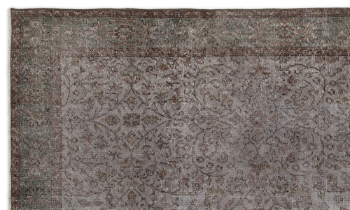 Load image 1 in gallery view. Distressed brown and sage green rug with a traditional floral medallion pattern and a wide border.