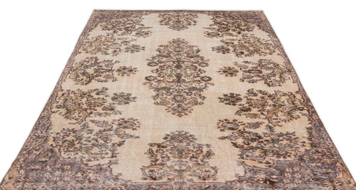 Load image 1 in gallery view. The Detiar Vintage Medallion Rug (5'9" x 9'5") features a beige flatwoven background with intricate floral patterns in brown, green, and gray, showcasing a symmetrical vintage design inspired by classic Anatolian heritage rugs.