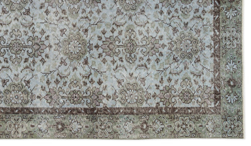 Load image 1 in gallery view. Light blue and sage green traditional rug with a distressed floral medallion pattern and a dark brown border.
