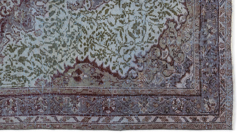 Load image 1 in gallery view. Distressed traditional rug in sage green, brown, and cream with an intricate floral medallion pattern and wide border.