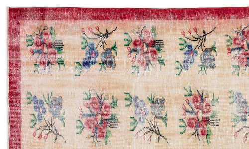 Load image 1 in gallery view. Beige rug with a red border and a repeating pattern of small, multicolored floral motifs.