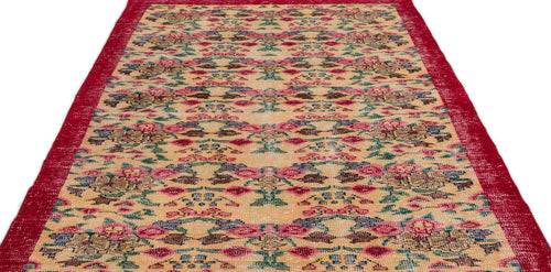 Load image 1 in gallery view. Beige vintage-style rug with a red border and a repeating floral and geometric pattern in red, green, and blue.