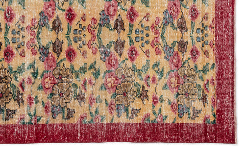 Load image 1 in gallery view. Distressed yellow rug with a floral pattern in red, green, and brown, featuring a solid red border.