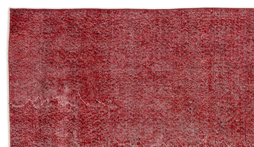 Load image 1 in gallery view. Deep red vintage-style rug with a faint, distressed geometric medallion pattern on a white background.