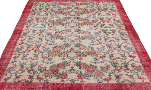 Load image 1 in gallery view. Beige rug with a distressed floral pattern in red, blue, and green, featuring a wide red border.