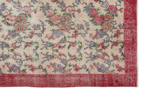 Load image 1 in gallery view. Beige rug with a multi-colored floral pattern in red, blue, and green, featuring a solid red border.