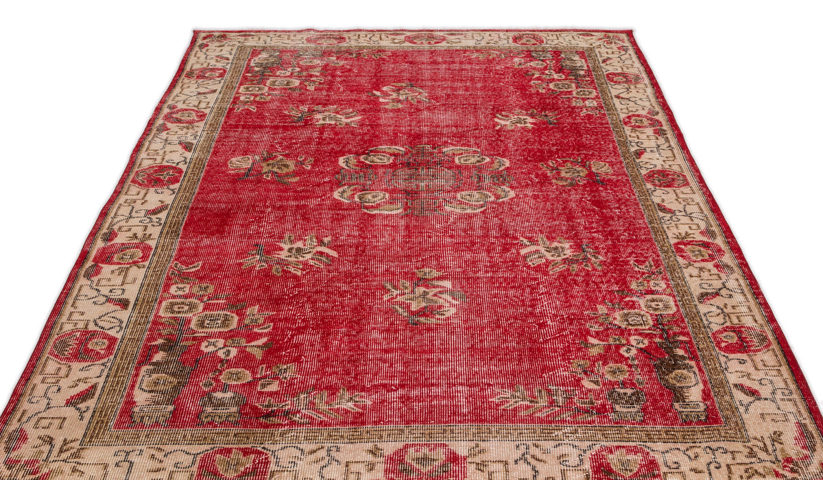 Red and beige distressed vintage-style rug with a central medallion and floral border pattern on a white background.