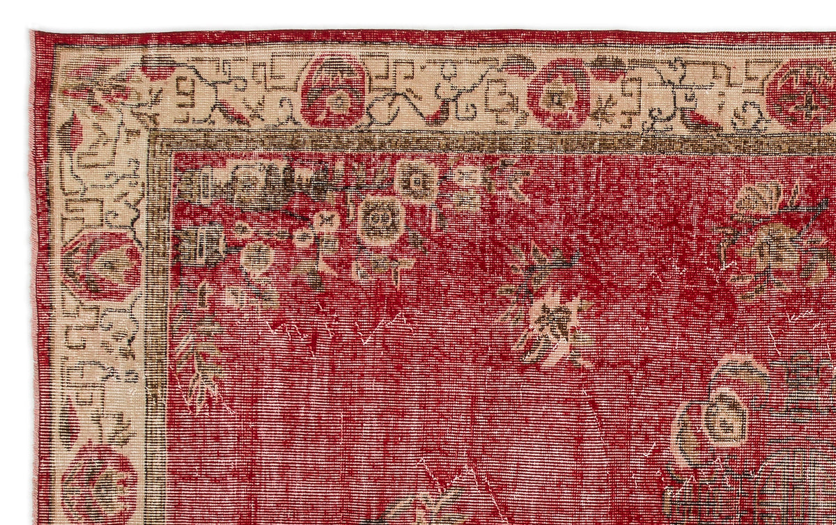 Red and beige vintage-style rug with a distressed floral medallion pattern and a decorative border.