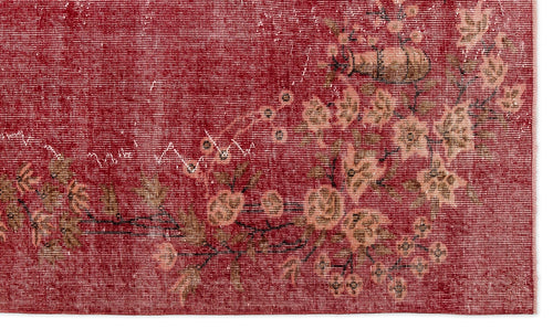 Load image 1 in gallery view. Deep red vintage-style rug with a distressed floral medallion pattern in muted beige and brown tones.