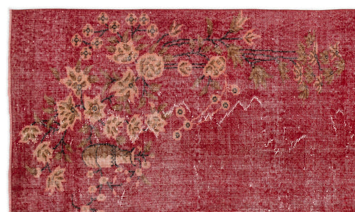 Load image 1 in gallery view. Distressed red rug with a faded floral motif in muted brown and cream tones.