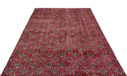 Load image 1 in gallery view. Red vintage-style rug with a repeating green and cream geometric floral pattern on a white background.
