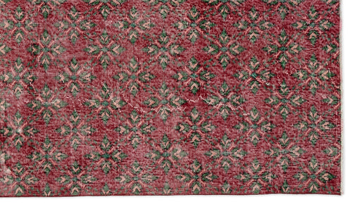 Load image 1 in gallery view. Deep red rug with a repeating geometric floral pattern in muted green and pale pink.