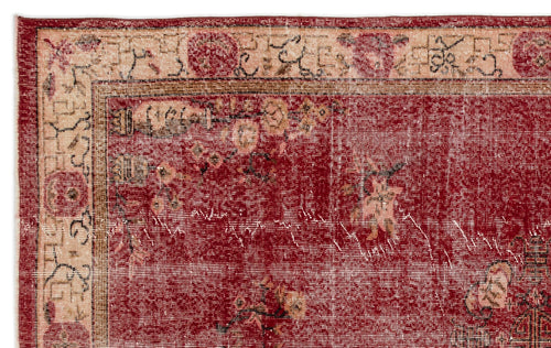 Load image 1 in gallery view. Distressed deep red rug with a beige floral border and traditional geometric motifs.