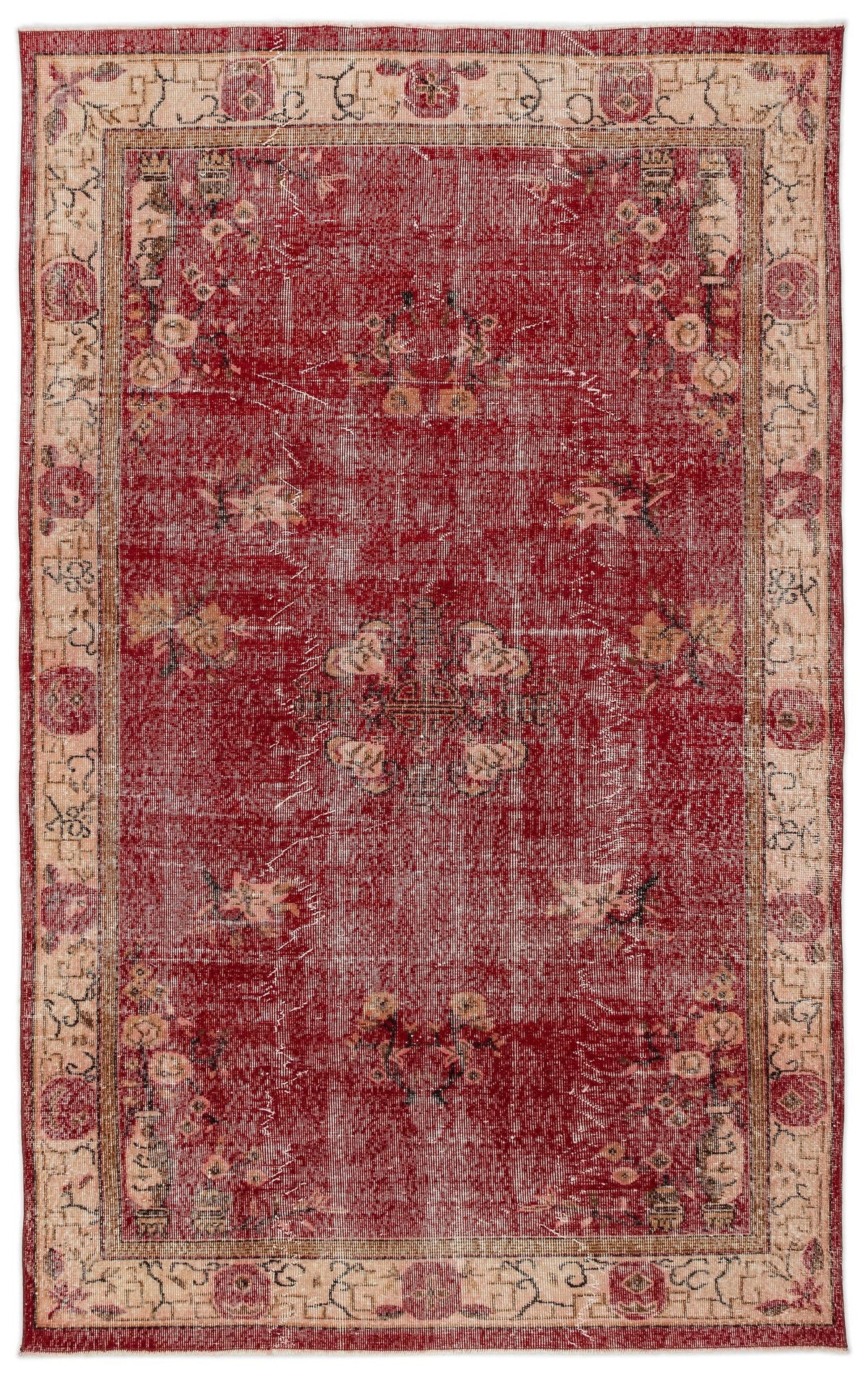 Distressed red rug with a central floral medallion and beige border featuring traditional geometric and floral motifs.