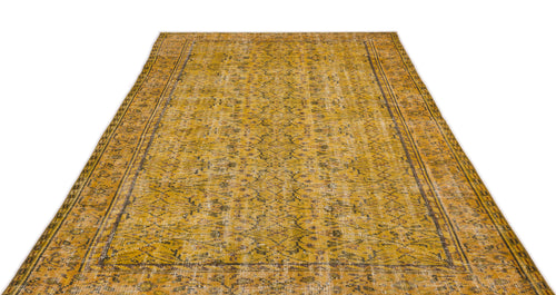 Load image 1 in gallery view. Mustard yellow vintage-style rug with a distressed floral medallion pattern and dark brown border on a white background.