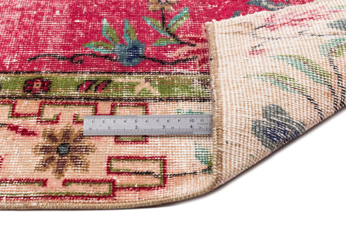 Load image 1 in gallery view. Distressed magenta and cream rug with floral motifs and geometric borders, shown with a metal ruler for scale.