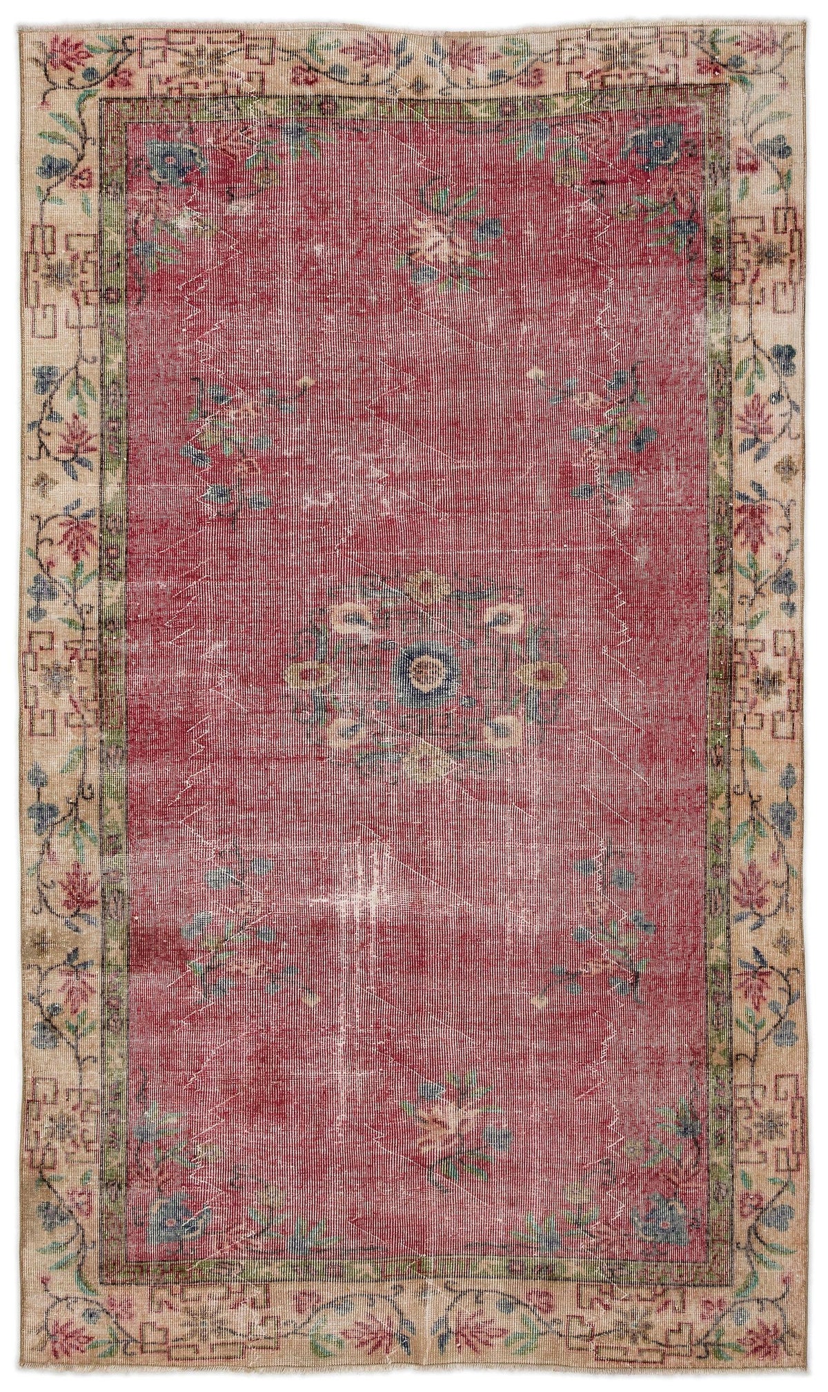 Distressed red rug with a central floral medallion and a beige border featuring geometric and floral motifs.