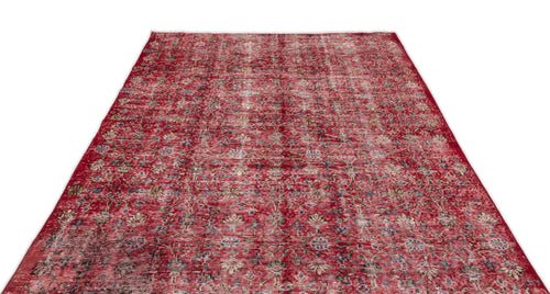 Load image 1 in gallery view. Distressed red rug with a faded floral medallion pattern and hints of blue and yellow on a white background.