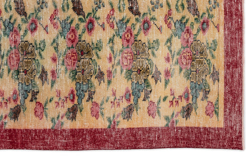 Load image 1 in gallery view. Beige rug with a distressed floral pattern in pink, green, and brown, featuring a solid deep red border.