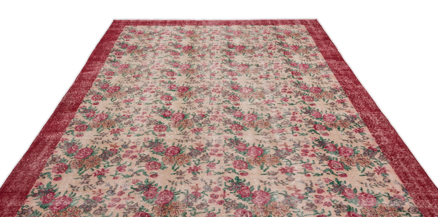 Distressed beige rug with a red floral pattern and a wide red border on a white background.