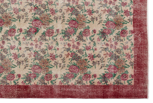 Load image 1 in gallery view. Beige rug with a distressed floral pattern in red, green, and brown, featuring a solid red border.