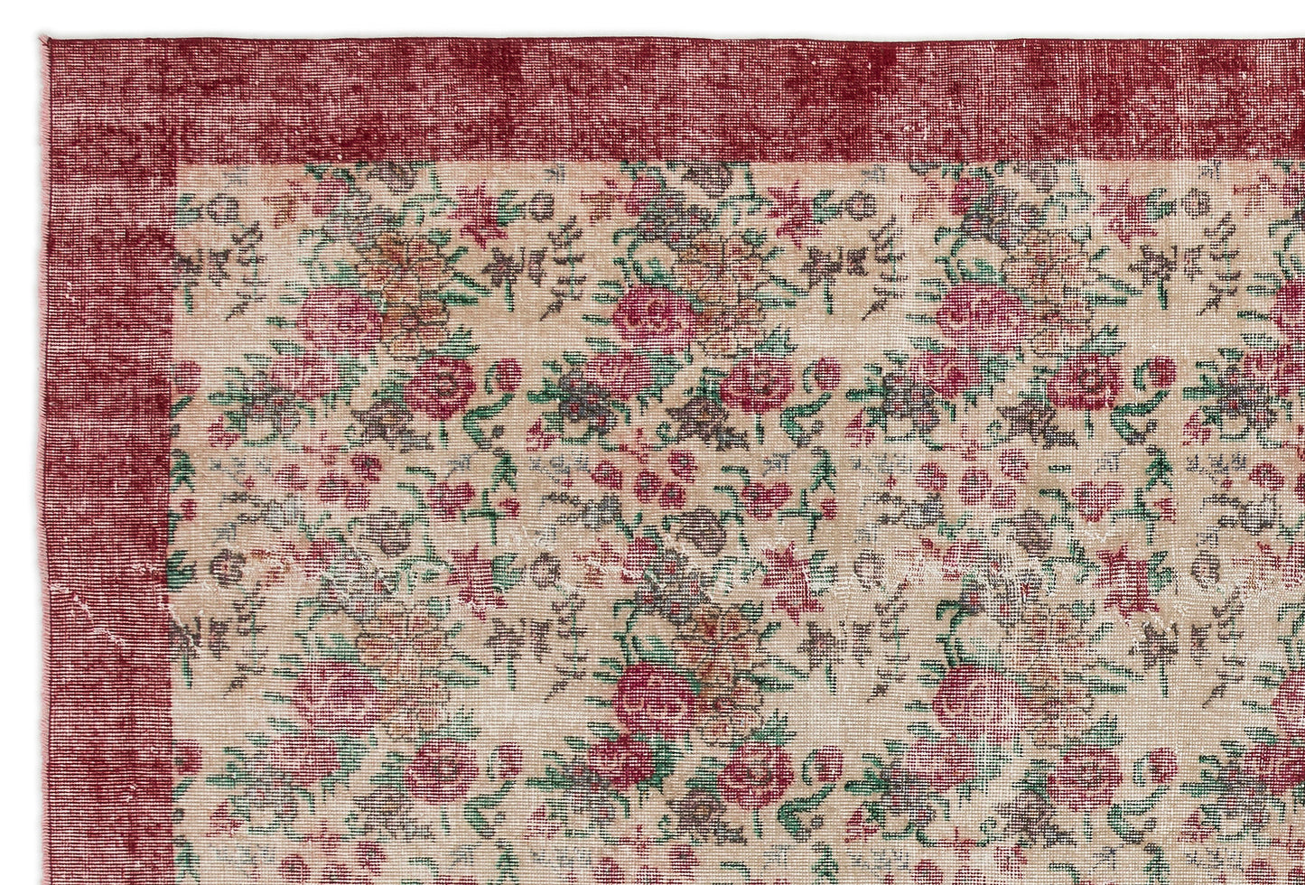 Distressed beige rug with a red border and a repeating floral pattern in shades of red, green, and brown.