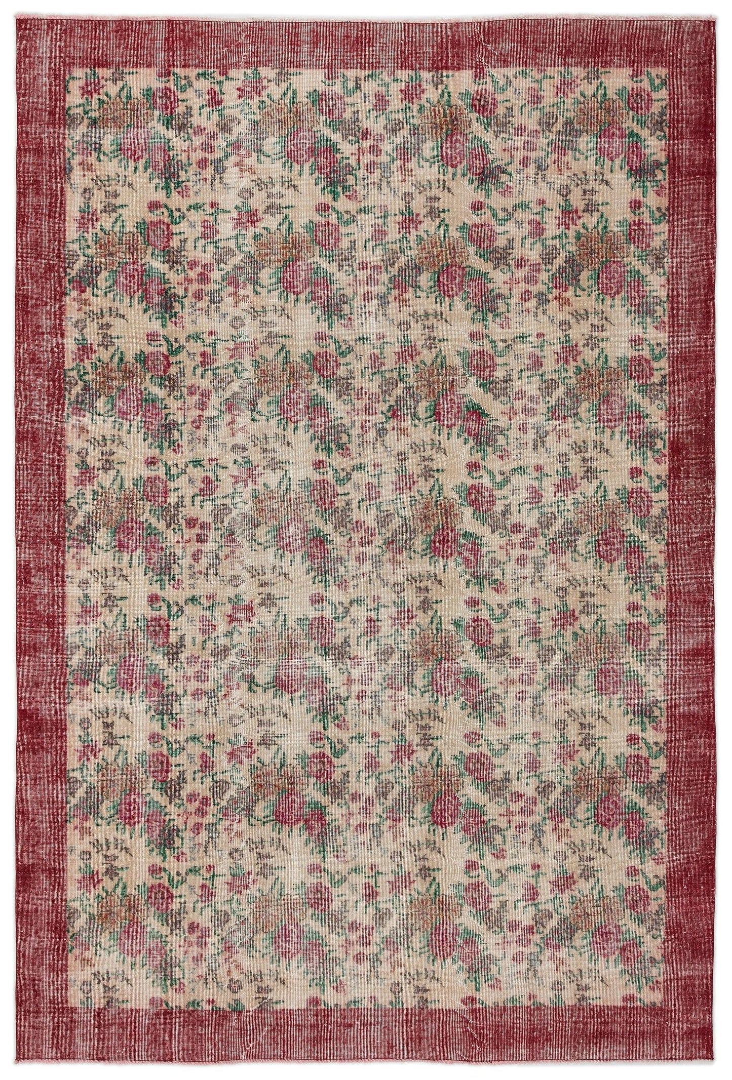 Distressed beige rug with a red border and an all-over floral pattern in shades of red, green, and brown.