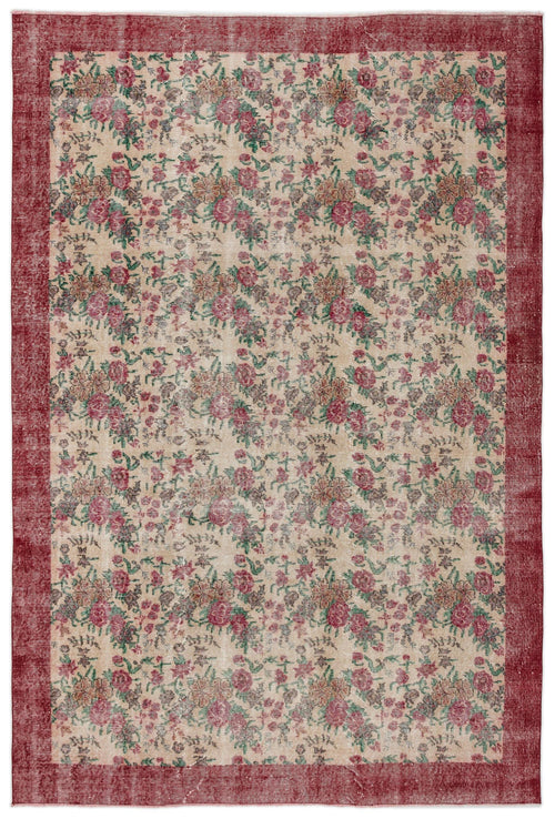 Load image 1 in gallery view. Distressed beige rug with a red border and an all-over floral pattern in shades of red, green, and brown.