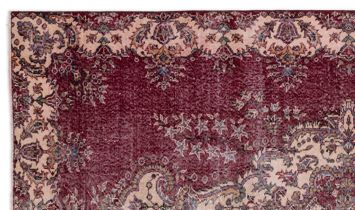Deep red and cream traditional rug with an intricate floral medallion pattern and distressed texture.