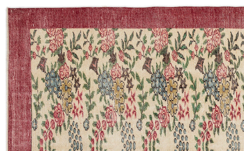 Load image 1 in gallery view. Cream rug with a red border and a repeating floral pattern in shades of pink, blue, yellow, and green.