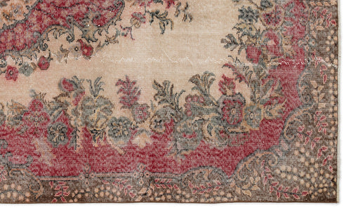 Load image 1 in gallery view. Distressed beige rug with a red and dark grey floral medallion pattern and a detailed border.