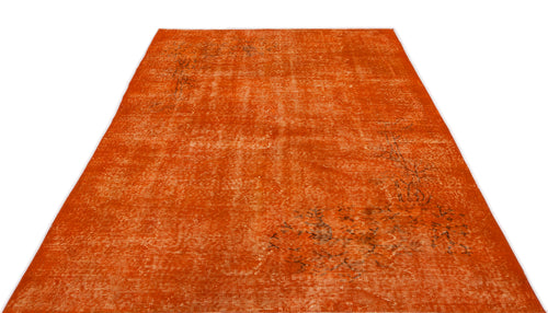Load image 1 in gallery view. Burnt orange distressed area rug with a faded, traditional floral pattern on a white background.