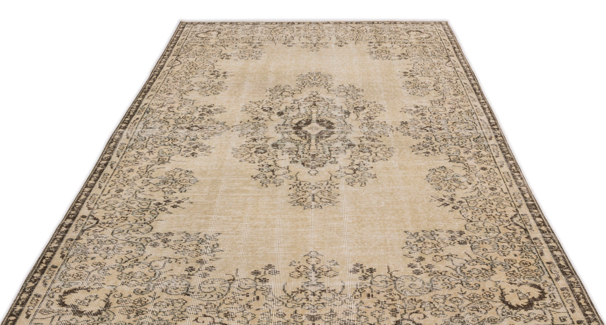 The Preutata Vintage Medallion Rug (5'4" x 8'11") is a rectangular beige area rug with an ornate floral medallion pattern in dark brown, a decorative border, and a slightly faded vintage look, inspired by classic Anatolian hand-woven designs.