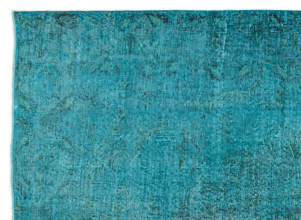 Teal distressed overdyed rug with a faint, worn traditional medallion pattern.