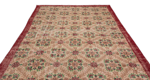 Load image 1 in gallery view. Beige rug with a red border and repeating floral medallion pattern in red and green on a white background.